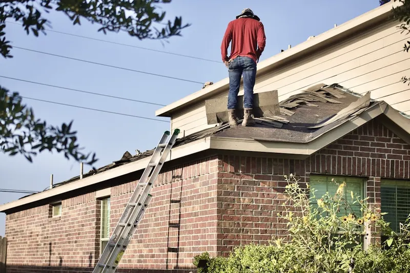 Professional roofer working on a residential roof in Warren Point